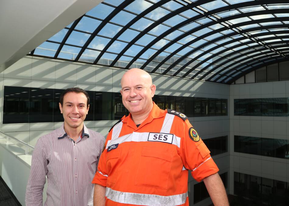 New home: Quality Green Group's Daniel Grozdanov with SES acting commissioner Greg Newton inside the former ATO building. Picture: Greg Ellis.